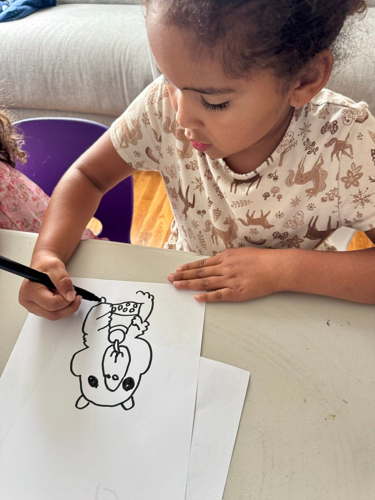 Real customer photo — child with their custom shaped Draw Pillow made from their own drawing — personalized kids pillow gift
